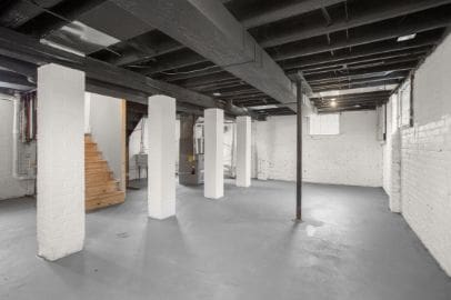 basement with heating unit and stairs