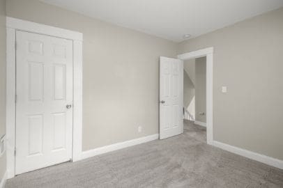 unfurnished bedroom with baseboards and carpet