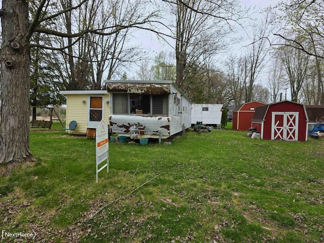 view of yard with a storage shed and an outbuilding