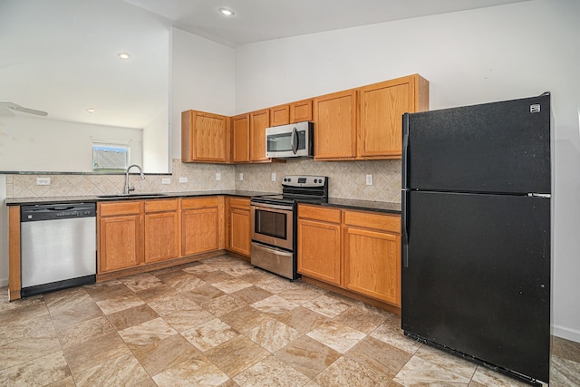 823 Glenlivet St, Howell, MI 48843 - kitchen with appliances with stainless steel finishes, a sink, tasteful backsplash, light stone finish floors, and recessed lighting