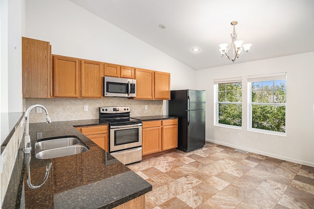 823 Glenlivet St, Howell, MI 48843 - kitchen featuring stainless steel appliances, a sink, tasteful backsplash, vaulted ceiling, and a chandelier