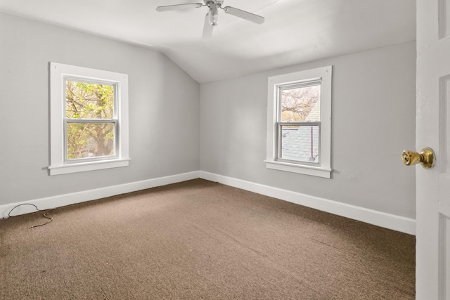 additional living space with baseboards, carpet flooring, ceiling fan, and vaulted ceiling