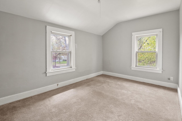 bonus room featuring plenty of natural light, carpet floors, and lofted ceiling