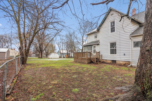 view of yard featuring a deck and fence