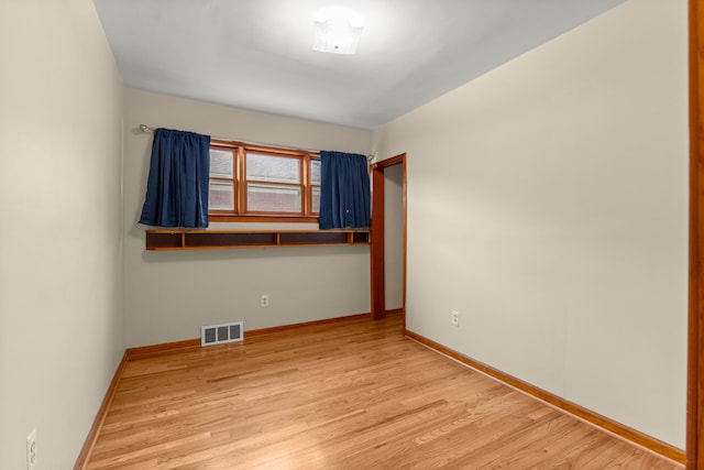 unfurnished room with wood finished floors and baseboards