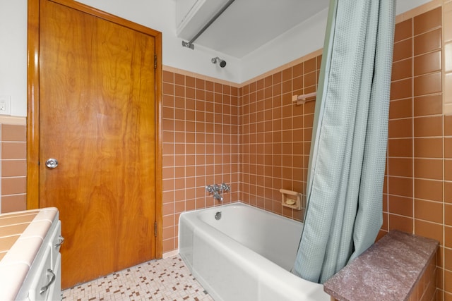 full bath with shower / bath combination with curtain, tile walls, and tile patterned floors