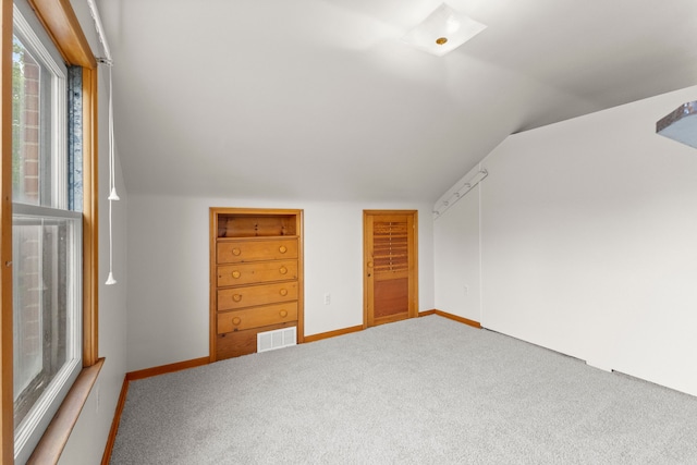 bonus room featuring vaulted ceiling, carpet flooring, and baseboards