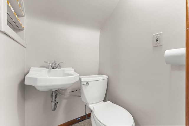 bathroom with toilet and baseboards