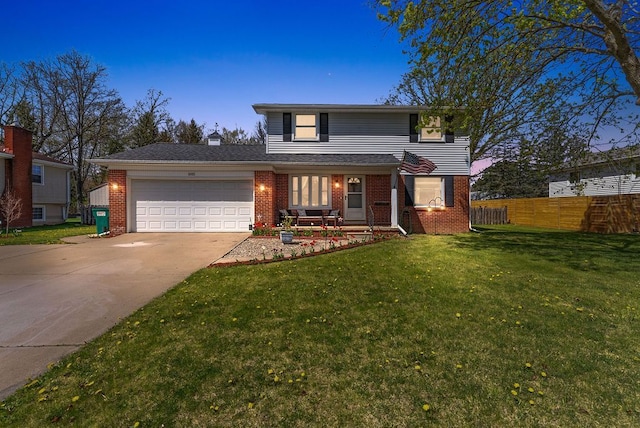 traditional-style house featuring brick siding, fence, a front lawn, concrete driveway, and an attached garage