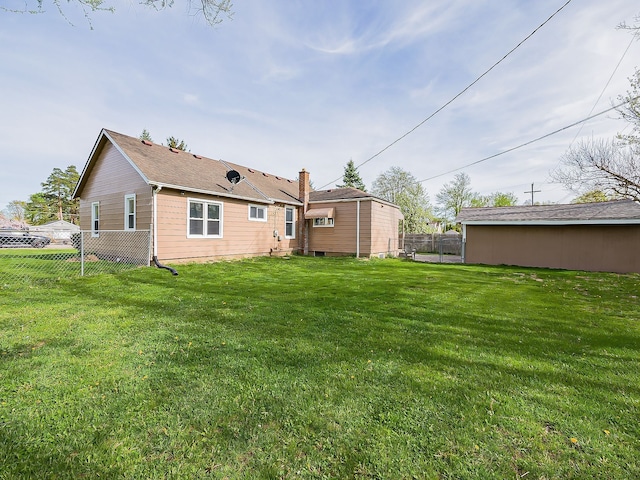 back of house featuring fence and a yard