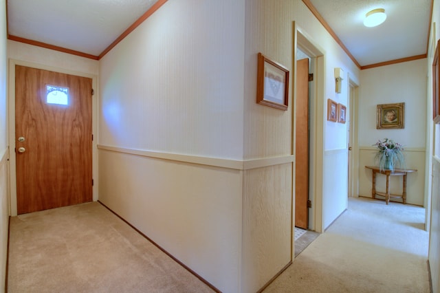 interior space with ornamental molding and carpet