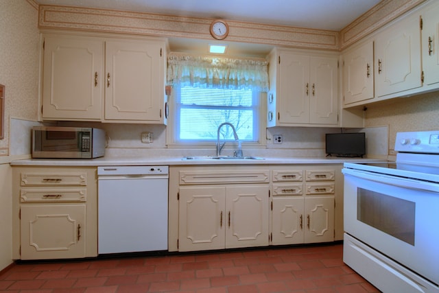 kitchen featuring a sink, white cabinets, white appliances, and light countertops