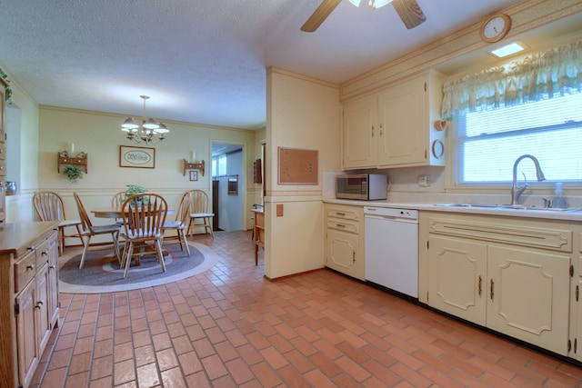 kitchen with a sink, stainless steel microwave, dishwasher, and brick floor