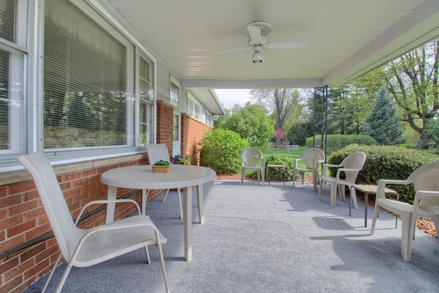 sunroom / solarium featuring ceiling fan