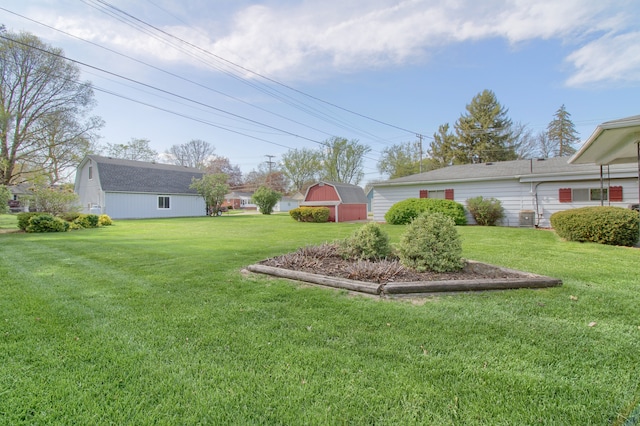 view of yard featuring central air condition unit and an outbuilding