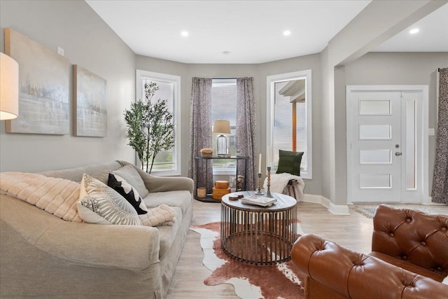 living area with baseboards, recessed lighting, and light wood finished floors