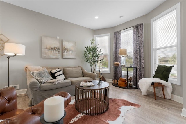 living area featuring recessed lighting, baseboards, visible vents, and light wood-type flooring