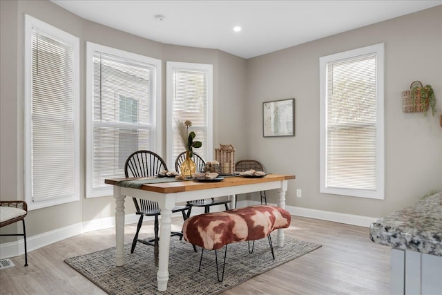 dining area with recessed lighting, baseboards, a wealth of natural light, and light wood-style floors