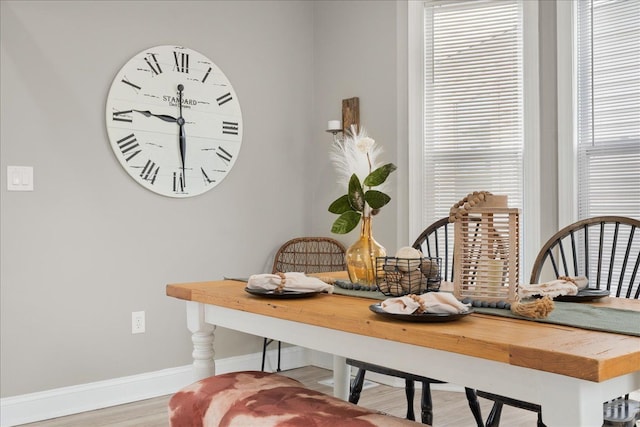 dining room with baseboards and wood finished floors