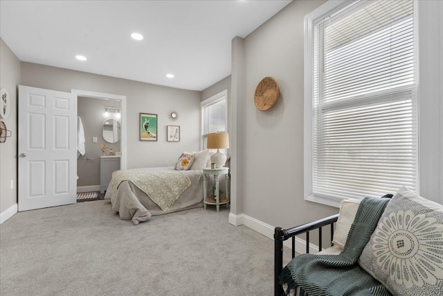 bedroom featuring baseboards, multiple windows, and carpet