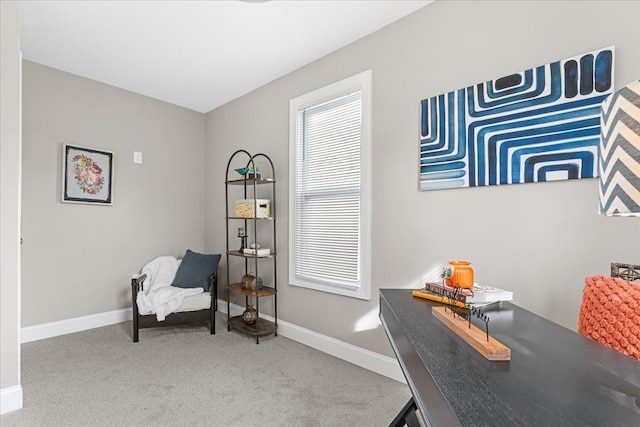 living area with baseboards and carpet