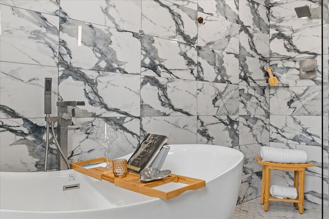 bathroom with a freestanding tub and tile walls