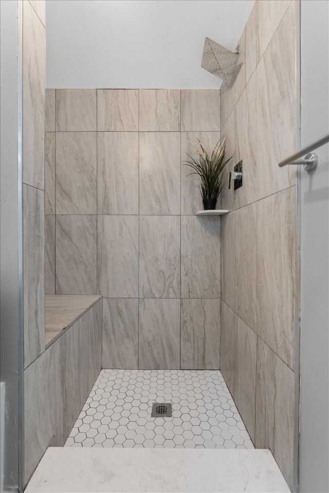 bathroom with tiled shower