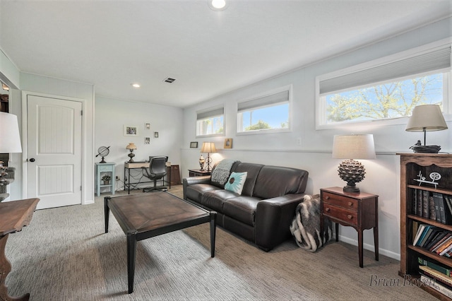 carpeted living area with recessed lighting, baseboards, and visible vents