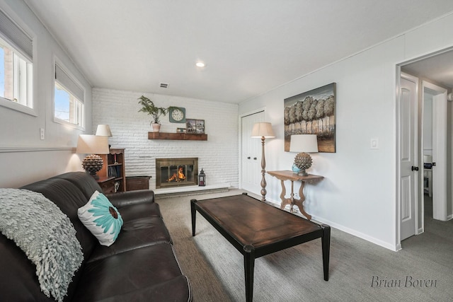 carpeted living area featuring baseboards, recessed lighting, visible vents, and a fireplace