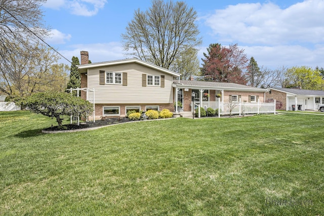 view of front of property with a porch, a front yard, and a chimney