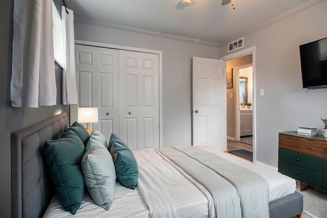 bedroom with a closet and crown molding