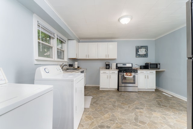 washroom with stone floors, laundry area, ornamental molding, and washer and dryer