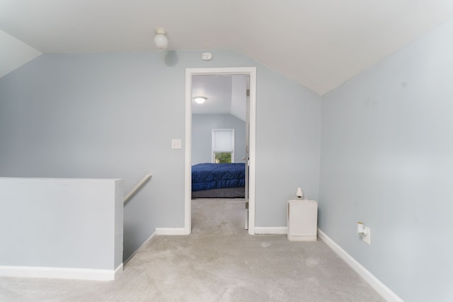 bonus room with carpet floors, baseboards, and lofted ceiling