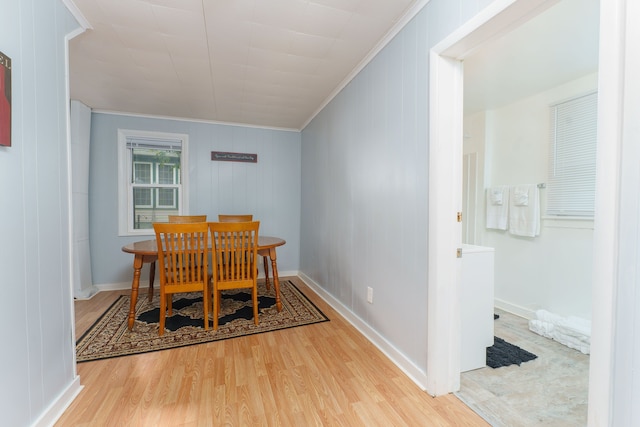 dining area with crown molding, baseboards, and wood finished floors