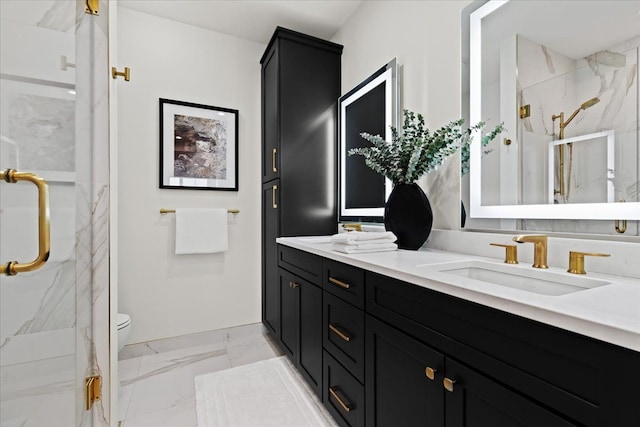 bathroom featuring a sink, double vanity, a marble finish shower, marble finish floor, and baseboards
