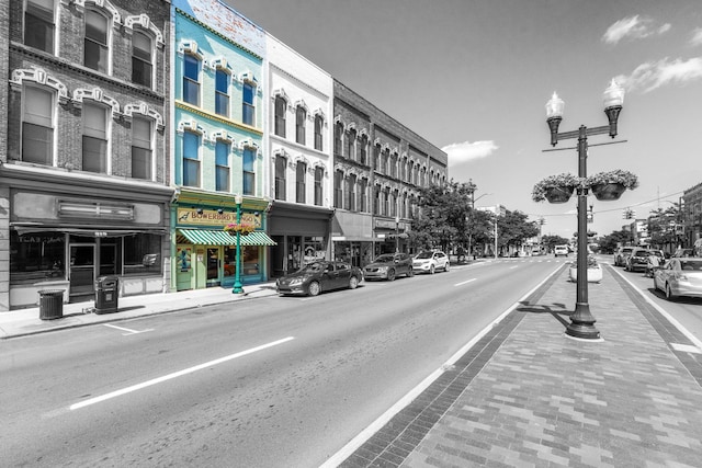 view of road with curbs, street lights, and sidewalks
