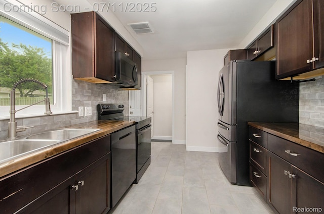 1082 Genella St, Waterford, MI 48328 - kitchen featuring appliances with stainless steel finishes, tasteful backsplash, dark brown cabinetry, dark countertops, and light tile patterned floors