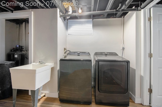 1082 Genella St, Waterford, MI 48328 - laundry area with light wood-style floors and independent washer and dryer