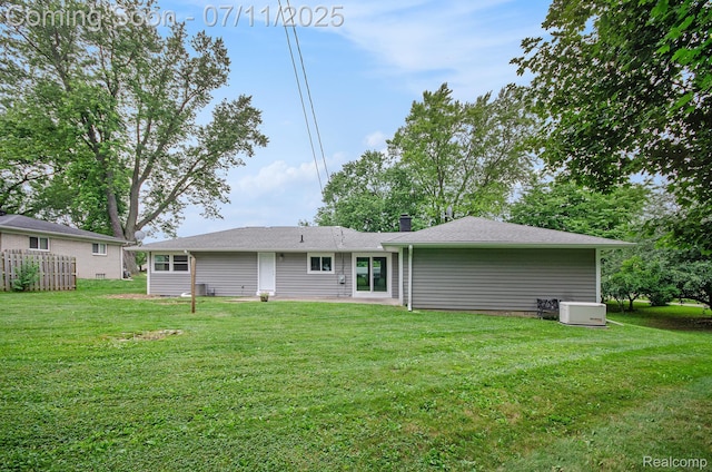 1082 Genella St, Waterford, MI 48328 - rear view of house with a lawn and a chimney