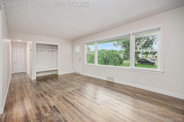 1082 Genella St, Waterford, MI 48328 - unfurnished living room featuring wood finished floors and baseboards