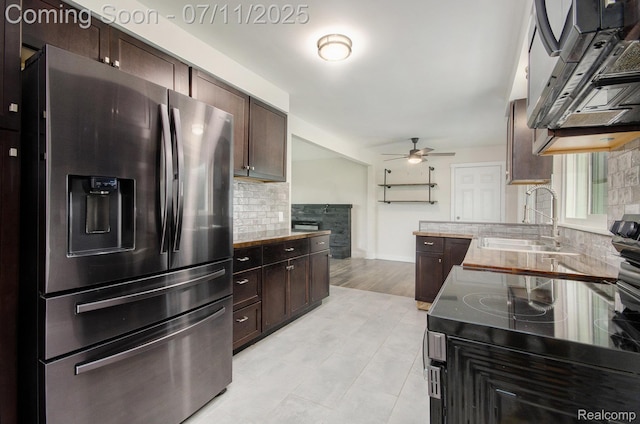 1082 Genella St, Waterford, MI 48328 - kitchen featuring stainless steel refrigerator with ice dispenser, exhaust hood, ceiling fan, backsplash, and dark brown cabinets