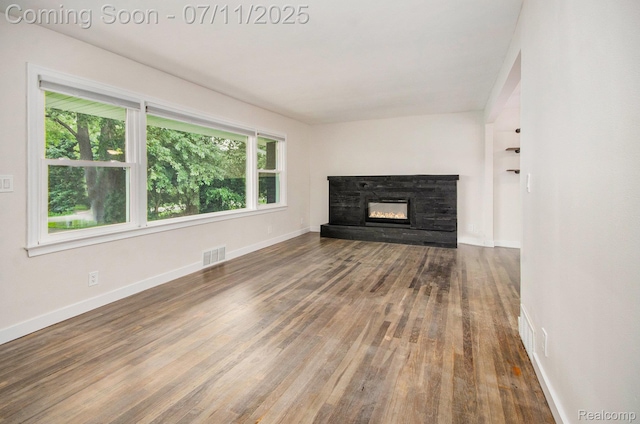 1082 Genella St, Waterford, MI 48328 - unfurnished living room featuring wood finished floors and a stone fireplace