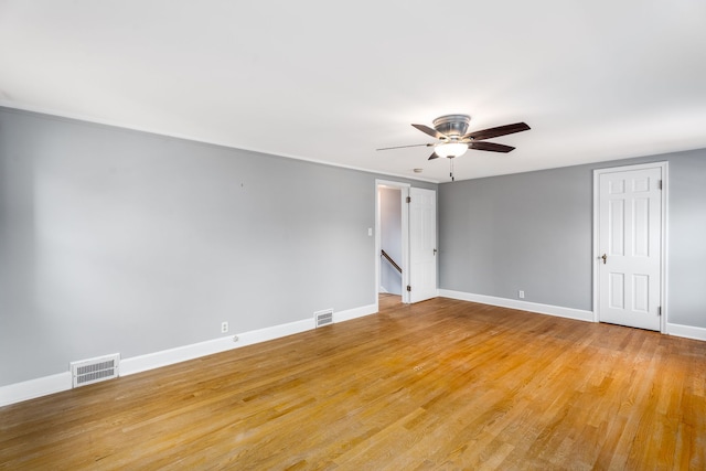 unfurnished room with visible vents, baseboards, light wood-style flooring, and ceiling fan