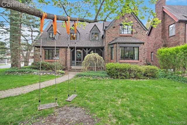 1301 Bishop Rd, Grosse Pointe Park, MI 48230 - view of front of property featuring a front yard, brick siding, and roof with shingles
