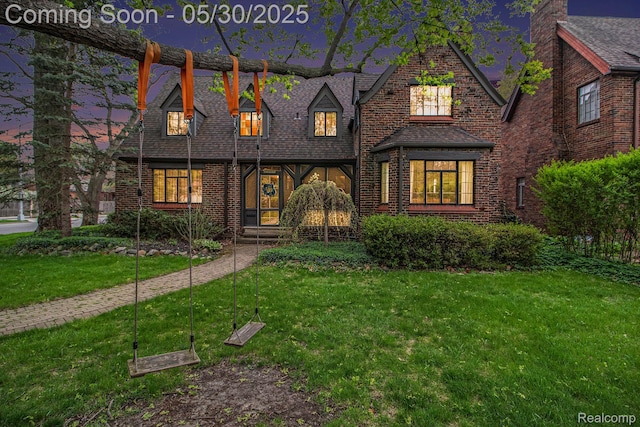 1301 Bishop Rd, Grosse Pointe Park, MI 48230 - tudor house with a front lawn, brick siding, and a shingled roof