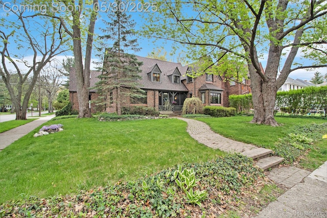1301 Bishop Rd, Grosse Pointe Park, MI 48230 - view of front facade with brick siding and a front lawn