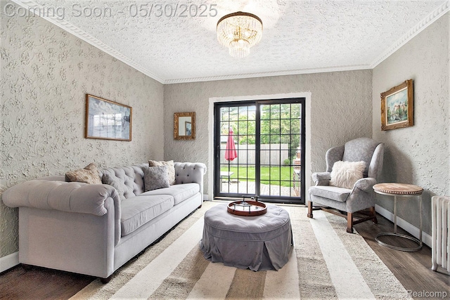 1301 Bishop Rd, Grosse Pointe Park, MI 48230 - living room featuring a textured ceiling, crown molding, wood finished floors, a textured wall, and a chandelier
