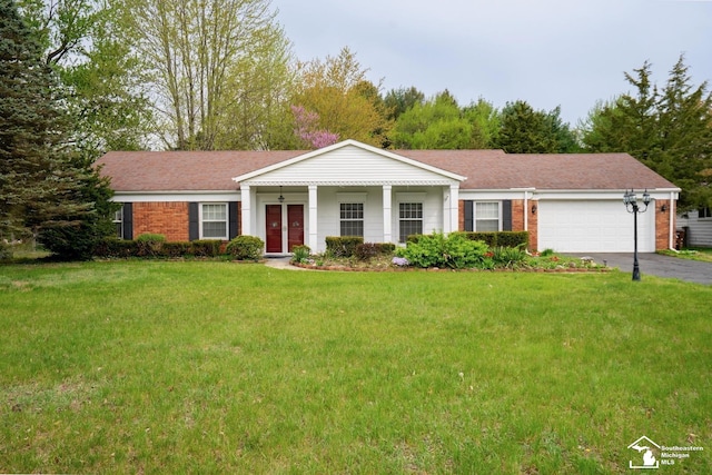 3336 Springdale St, Lambertville, MI 48144 - view of front of house with brick siding, a garage, aphalt driveway, and a front yard