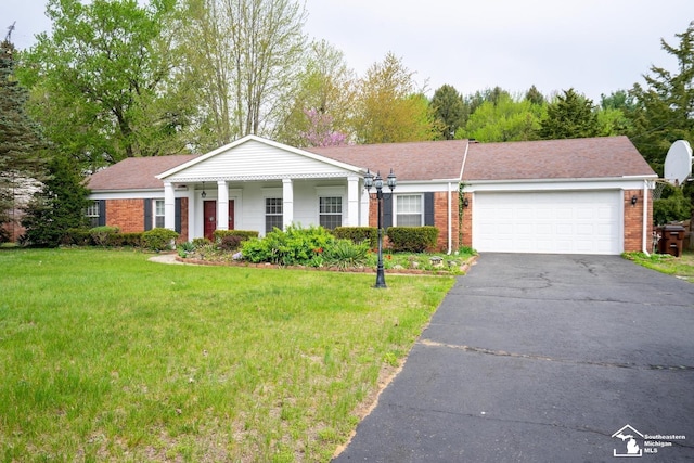3336 Springdale St, Lambertville, MI 48144 - view of front of house featuring a garage, a front yard, driveway, and brick siding