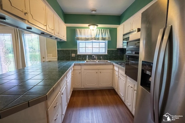 3336 Springdale St, Lambertville, MI 48144 - kitchen featuring white cabinets, a sink, stainless steel appliances, decorative backsplash, and dark wood-type flooring